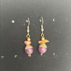 Silver tone hooks & gold tone metal  accents. Purple and orangey beads. Pierced